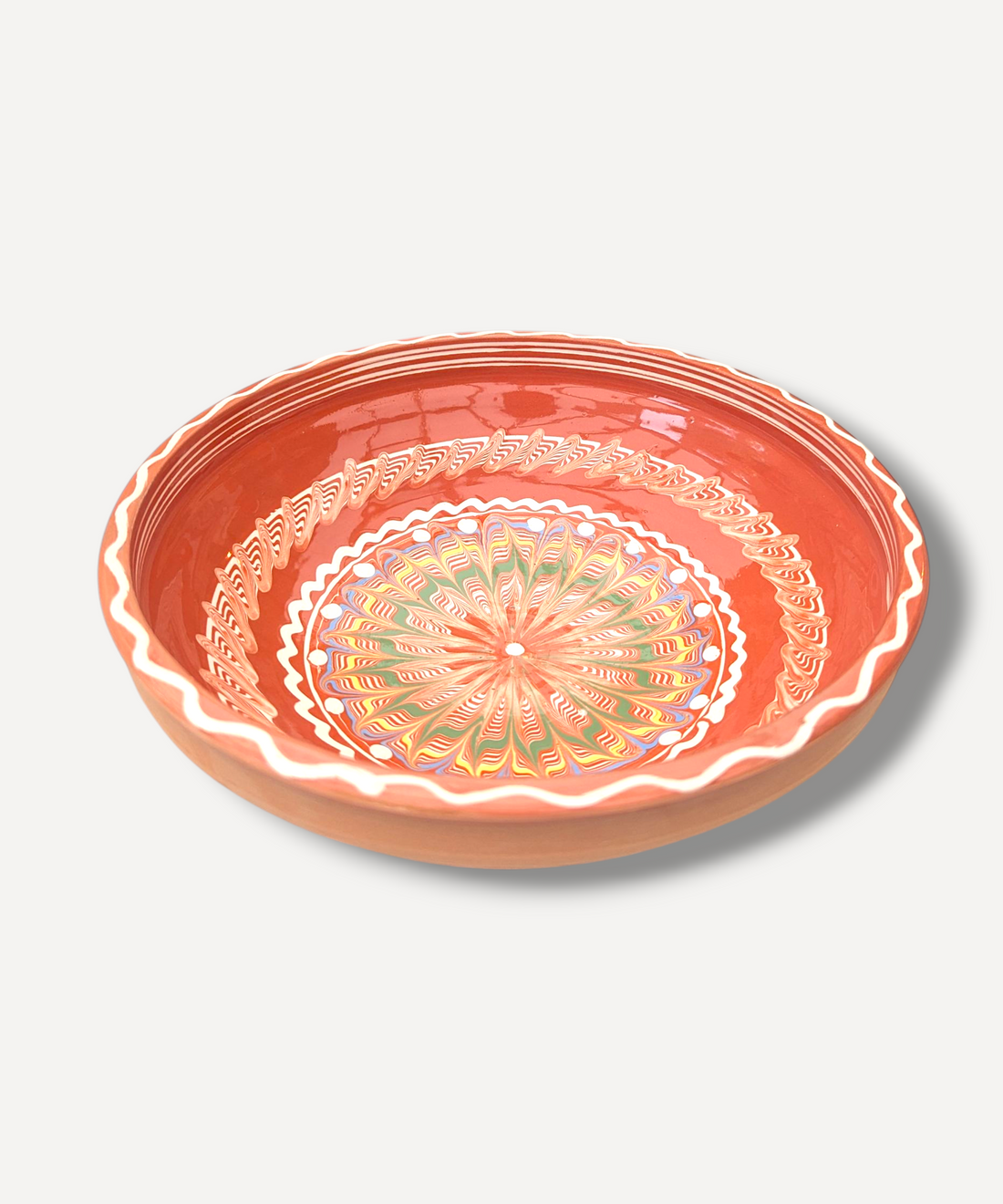 Handcrafted bowl with a colourful mandala design on a white background