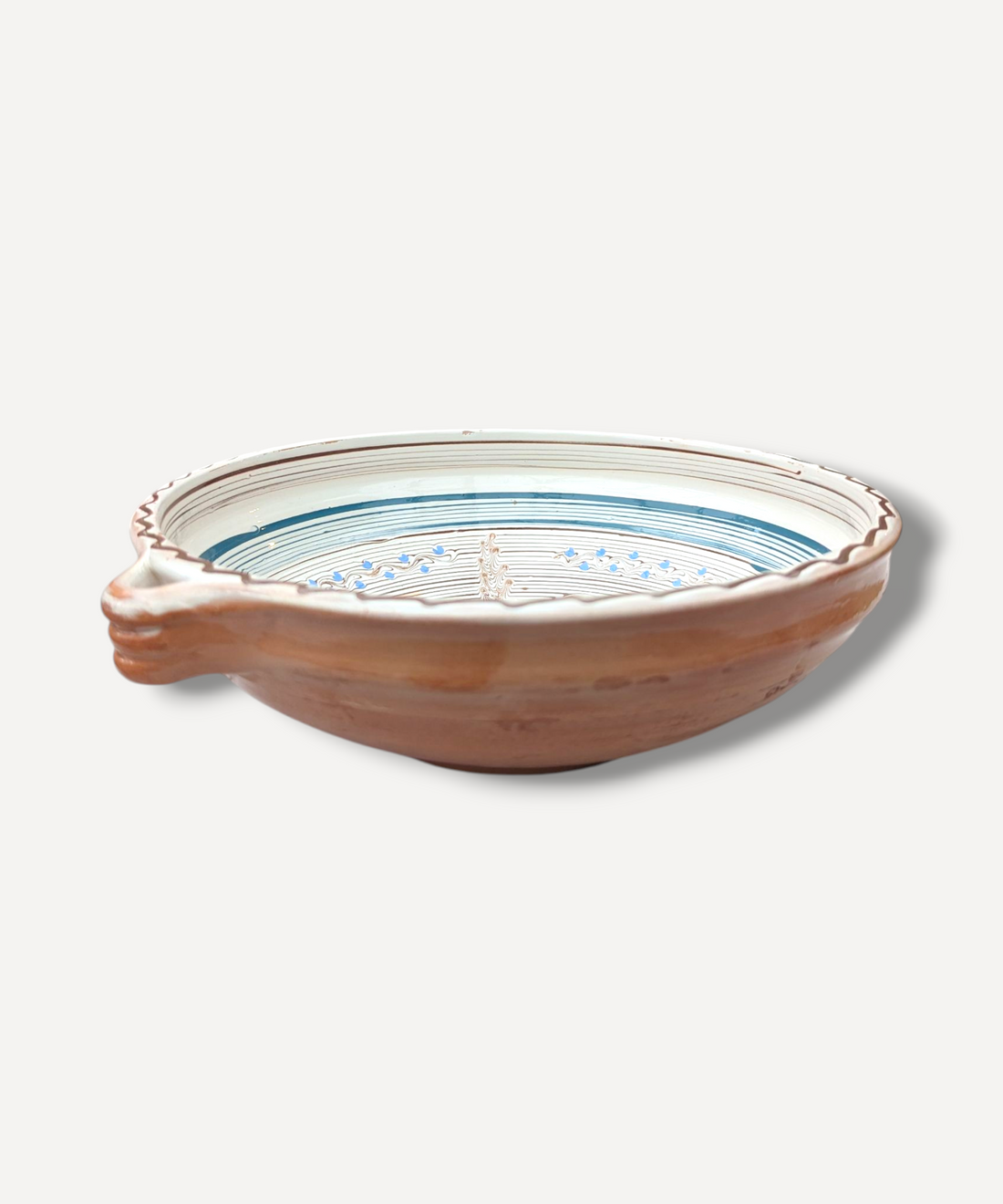 Ceramic bowl with decorative rim on a white background