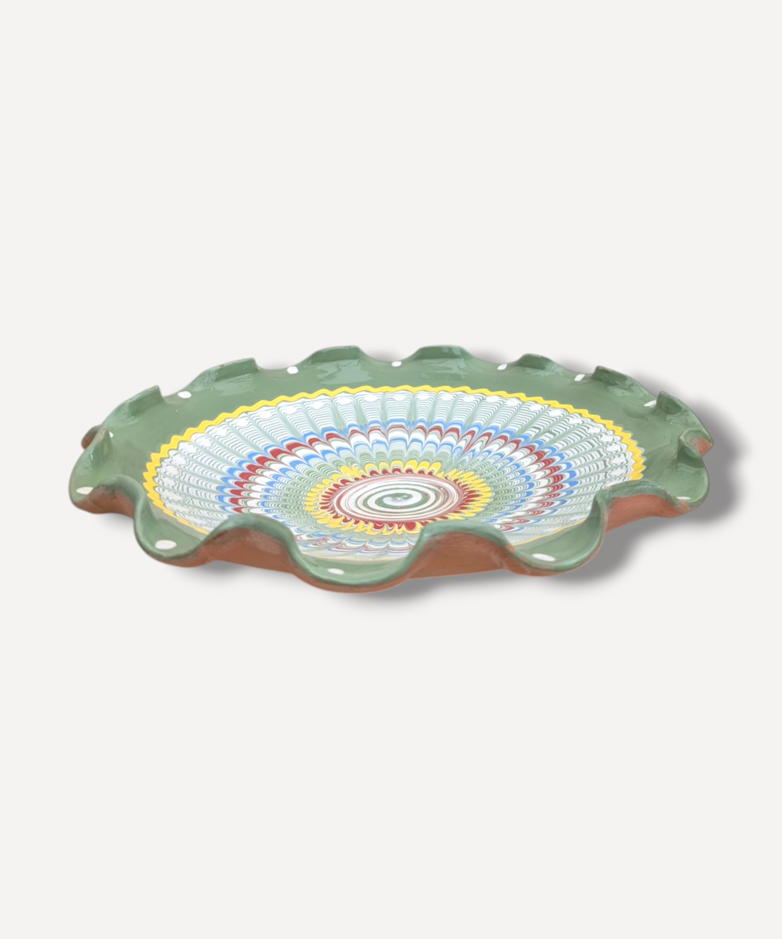 Decorative ceramic plate with colorful concentric circle design on a white background