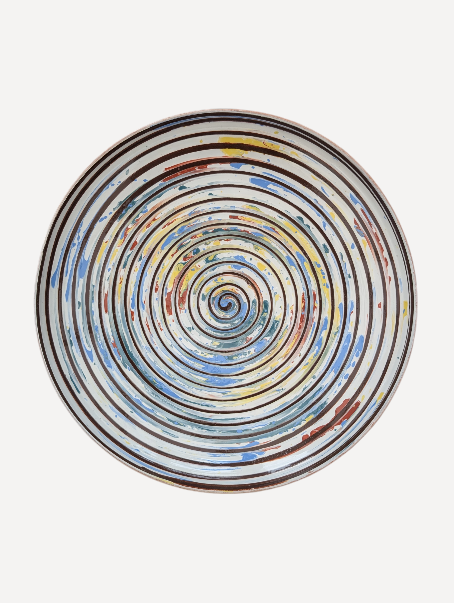 Hand decorated Romanian ceramic platter with spiral folk pattern in blue ochre and terracotta tones