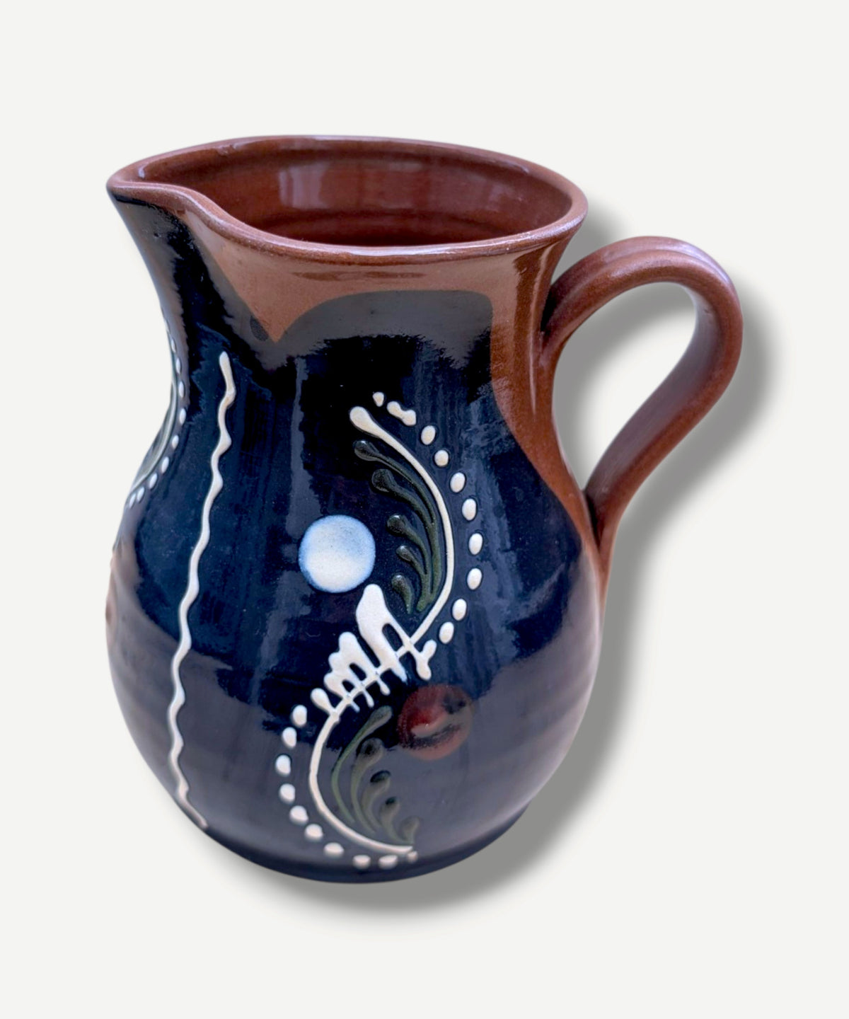 Handmade cobalt-blue Romanian earthenware jug with vertical white wavy lines, dotted motifs and a chocolate-brown rim.