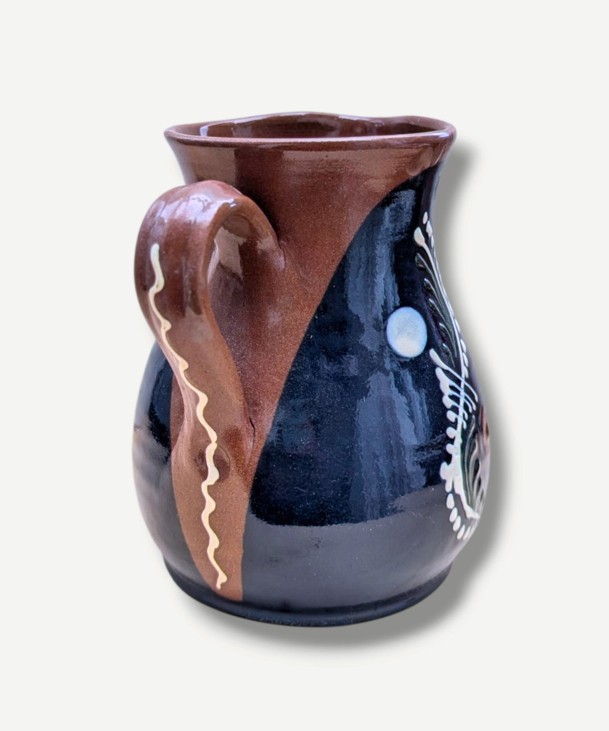 Handmade cobalt-blue Romanian earthenware jug with vertical white wavy lines, dotted motifs and a chocolate-brown rim.