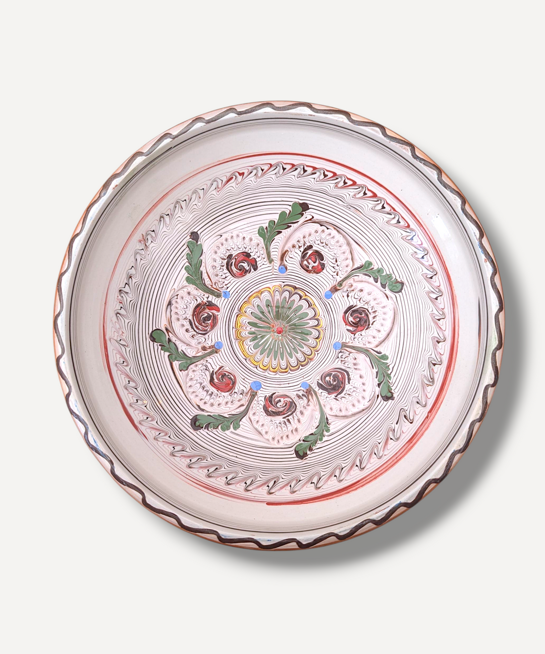 Decorative plate with intricate patterns on a white background