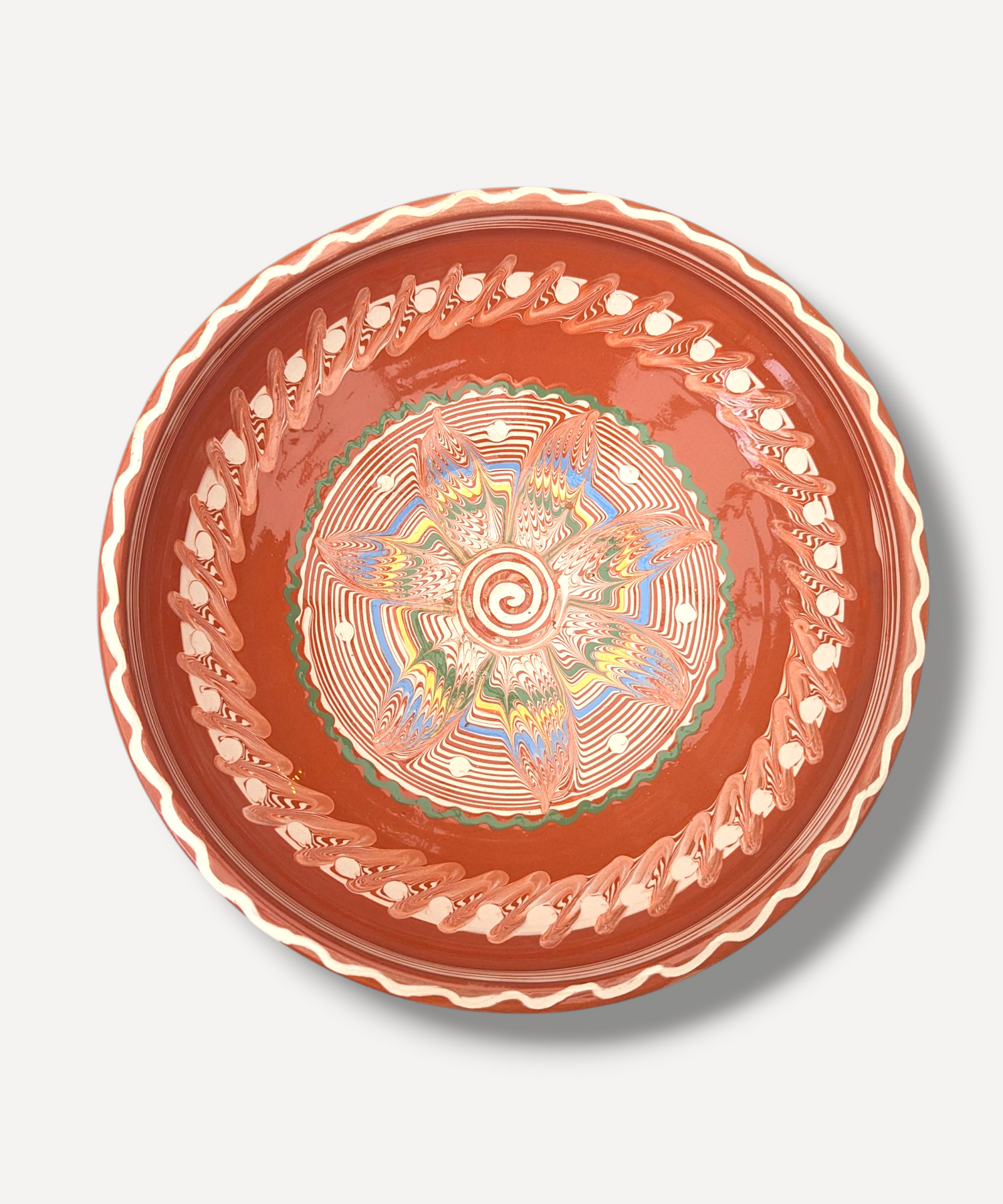 Decorative ceramic plate with intricate design on a white background
