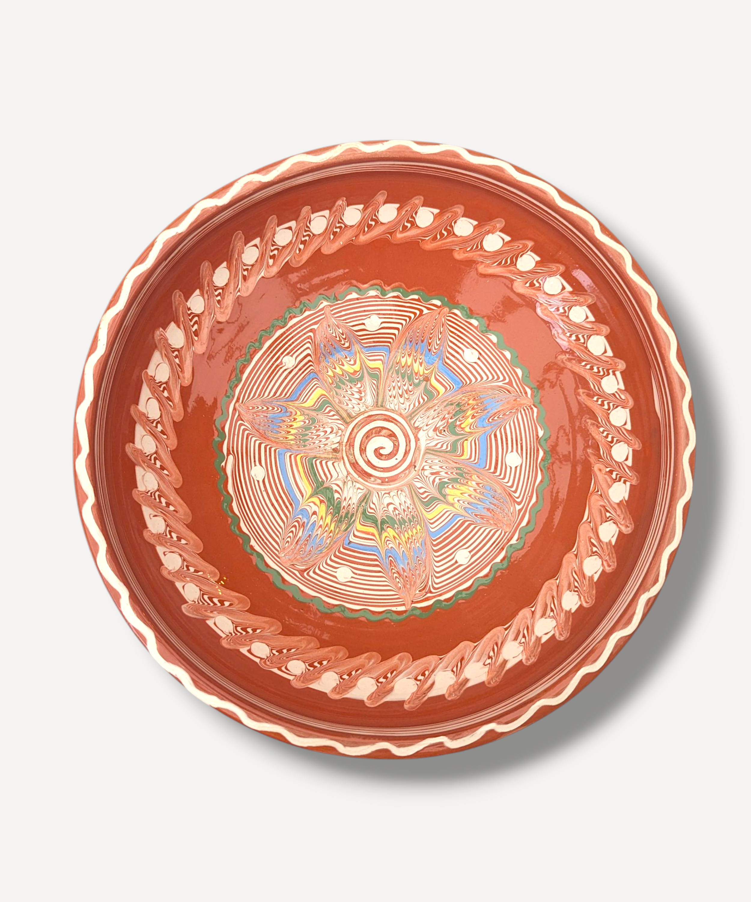 Decorative ceramic plate with intricate design on a white background
