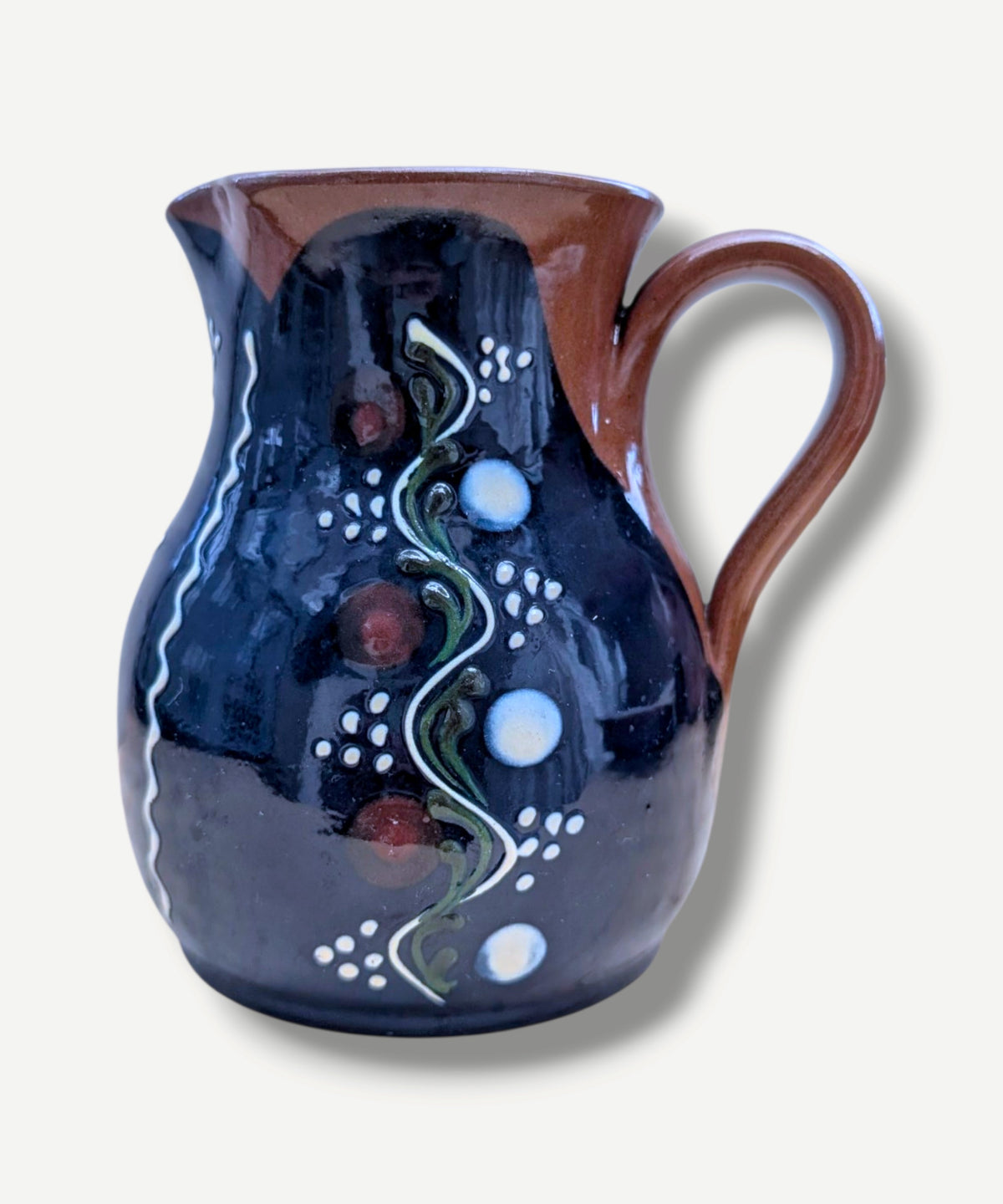 Handmade cobalt-blue Romanian earthenware jug with vertical white wavy lines, dotted motifs and a chocolate-brown rim.