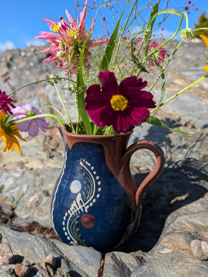 Handmade cobalt-blue Romanian earthenware jug with vertical white wavy lines, dotted motifs and a chocolate-brown rim.