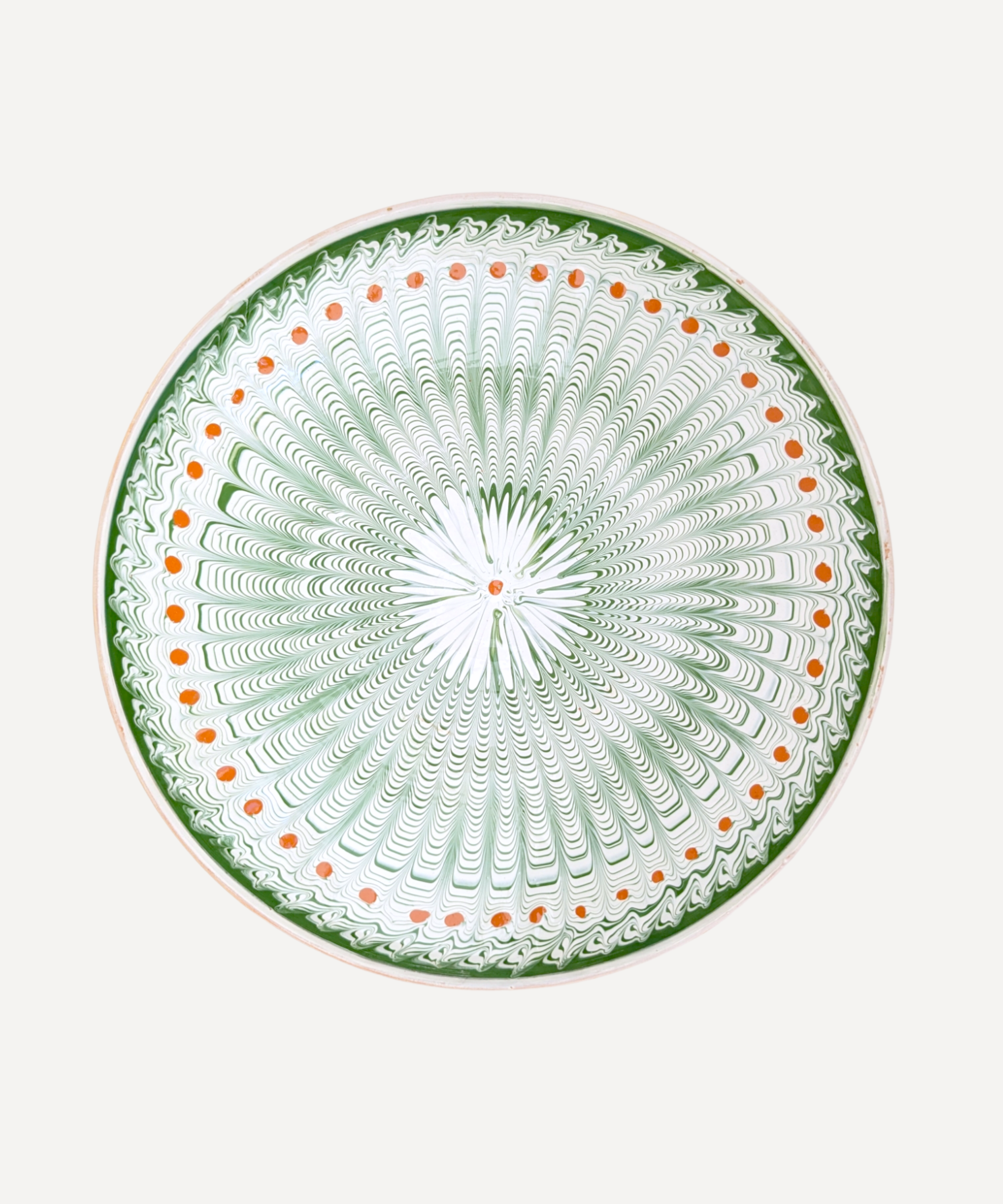 A large serving plate with a pattern in green and ginger detail, featuring a central motif surrounded by a border with a similar design.