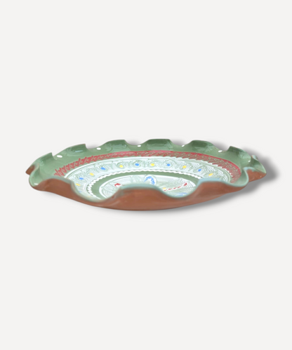 Decorative ceramic plate with floral patterns on a white background