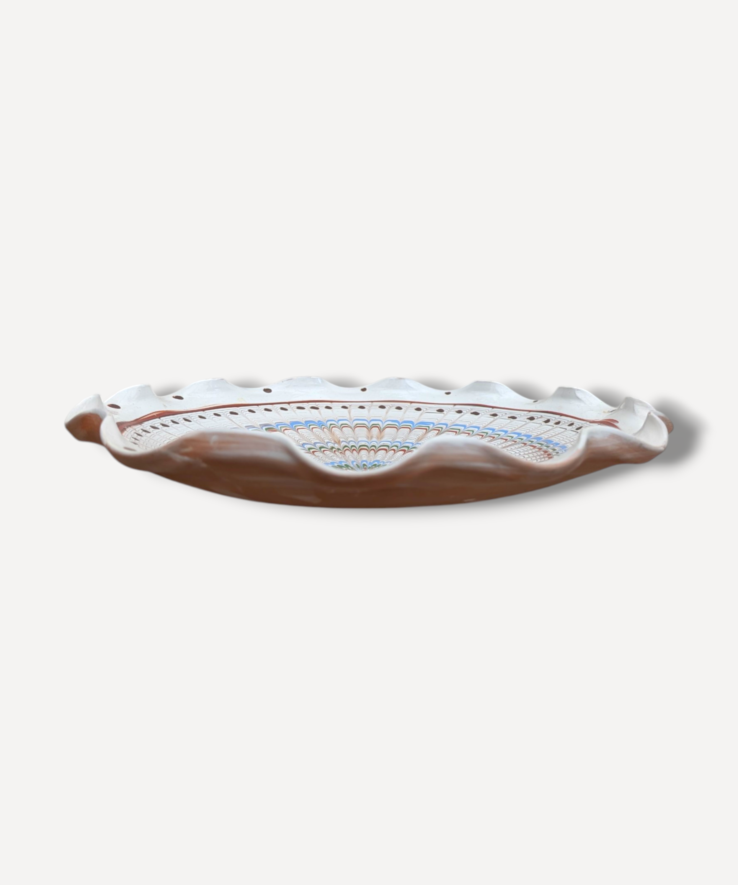 Romanian earthenware serving platter with radial folk decoration in terracotta blue and green