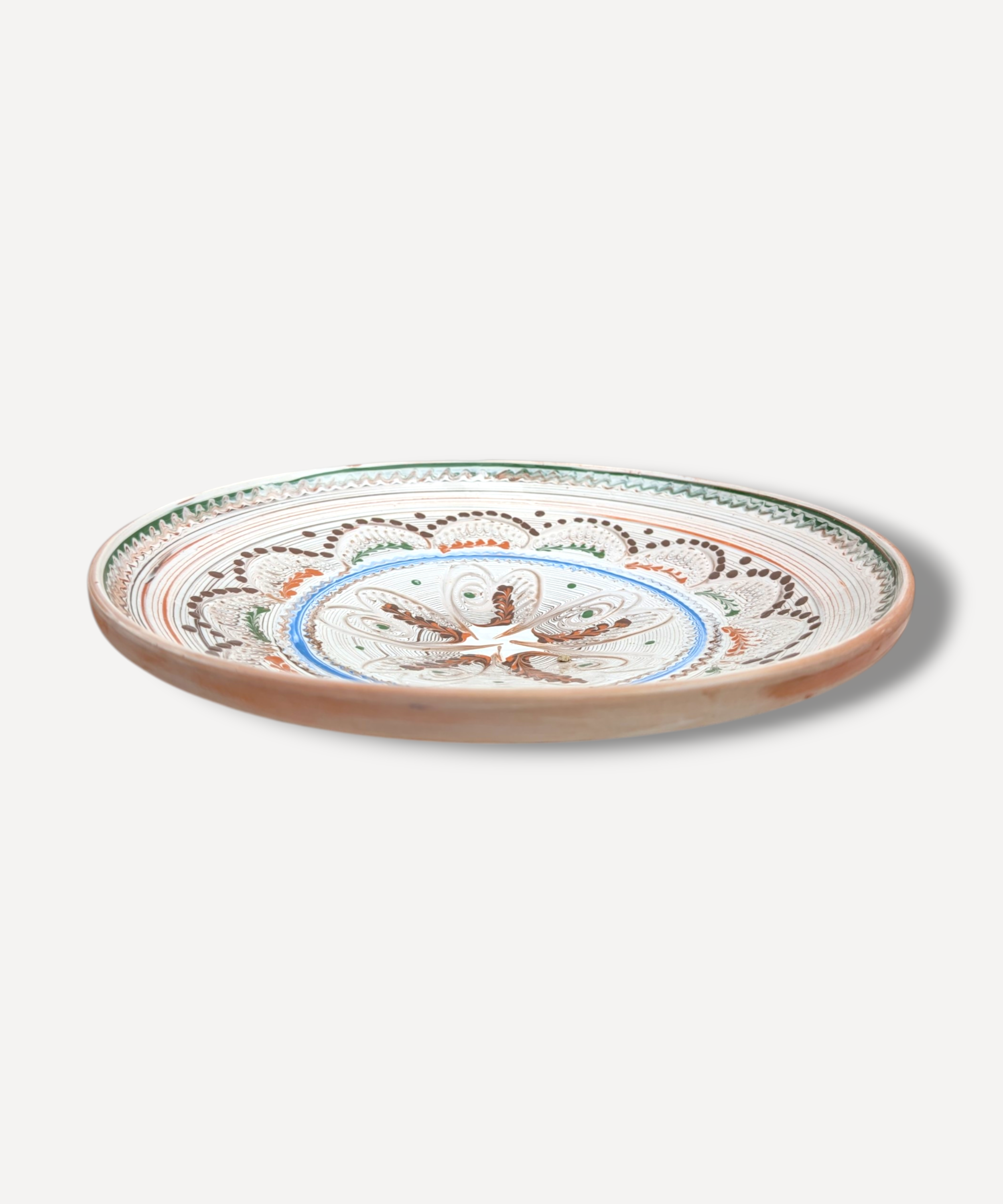 Hand decorated Romanian ceramic platter with floral star folk motif and terracotta border