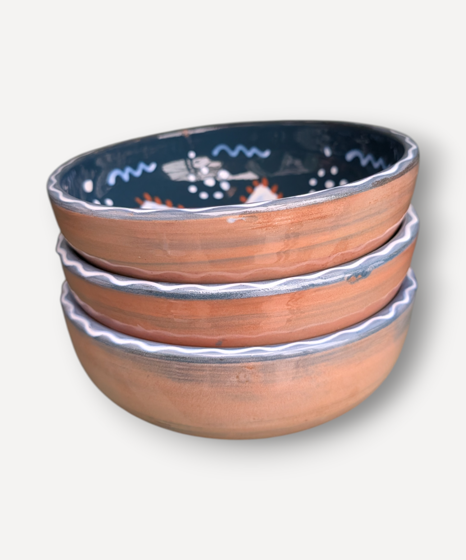 Set of three ceramic bowls with decorative patterns on a white background