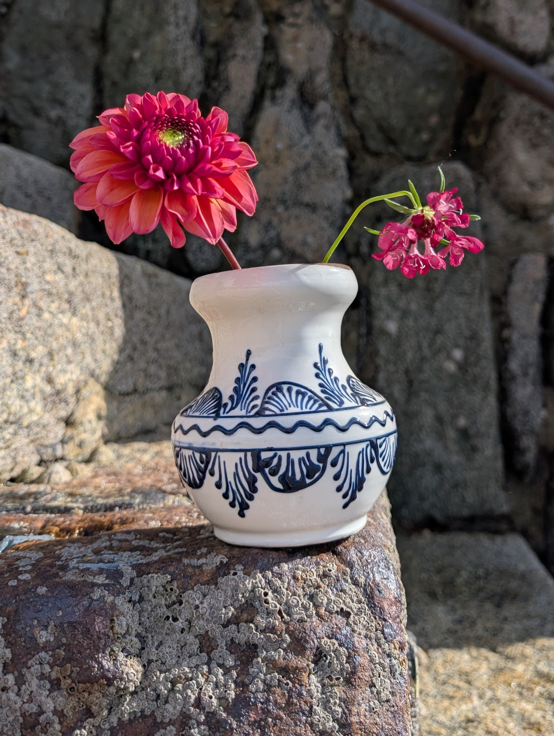 Handmade white Romanian earthenware vase with black floral motifs, a rounded body and a sculptural narrow waist. By Casa De Folklore