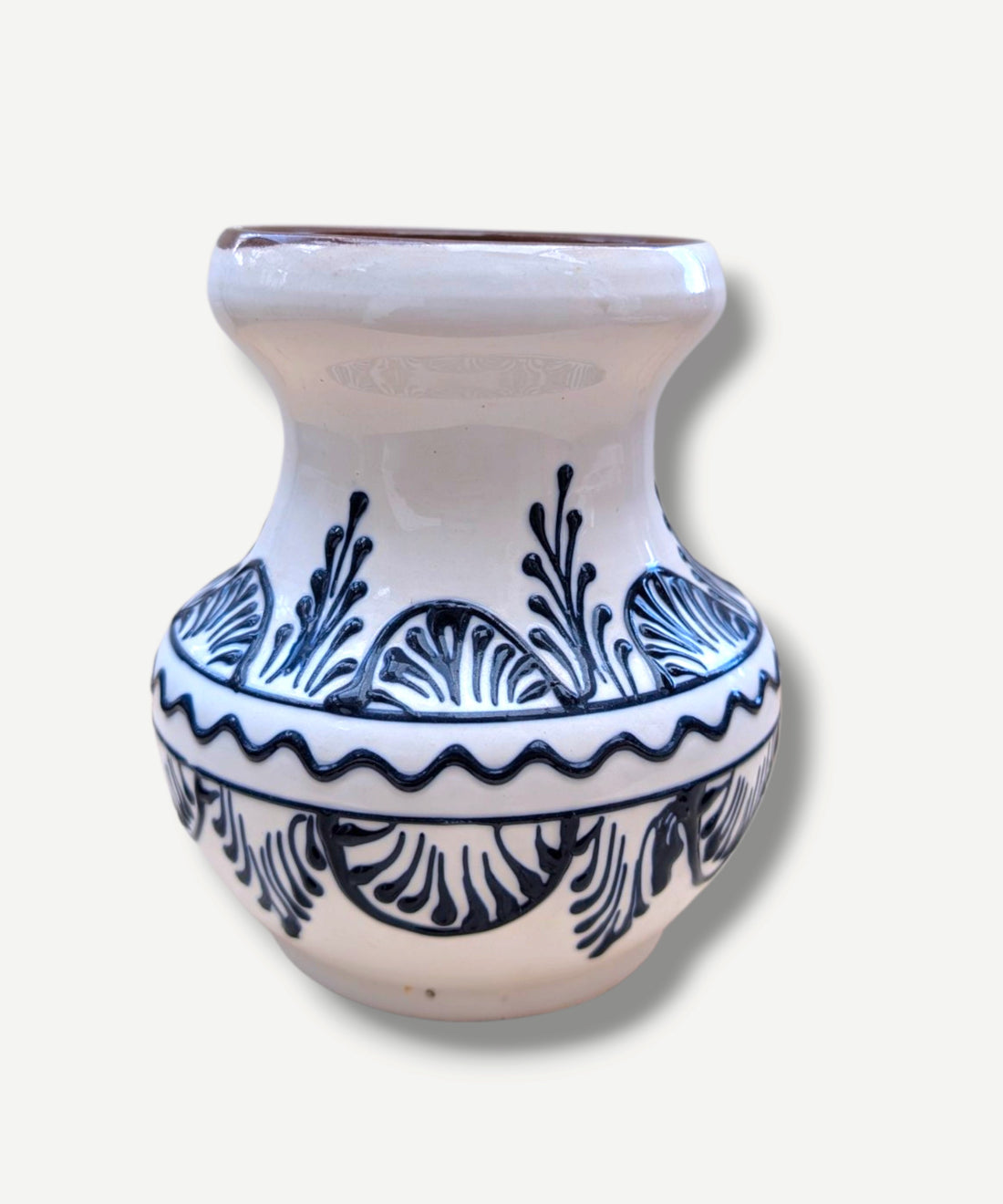 Handmade white Romanian earthenware vase with black floral motifs, a rounded body and a sculptural narrow waist. By Casa De Folklore 
