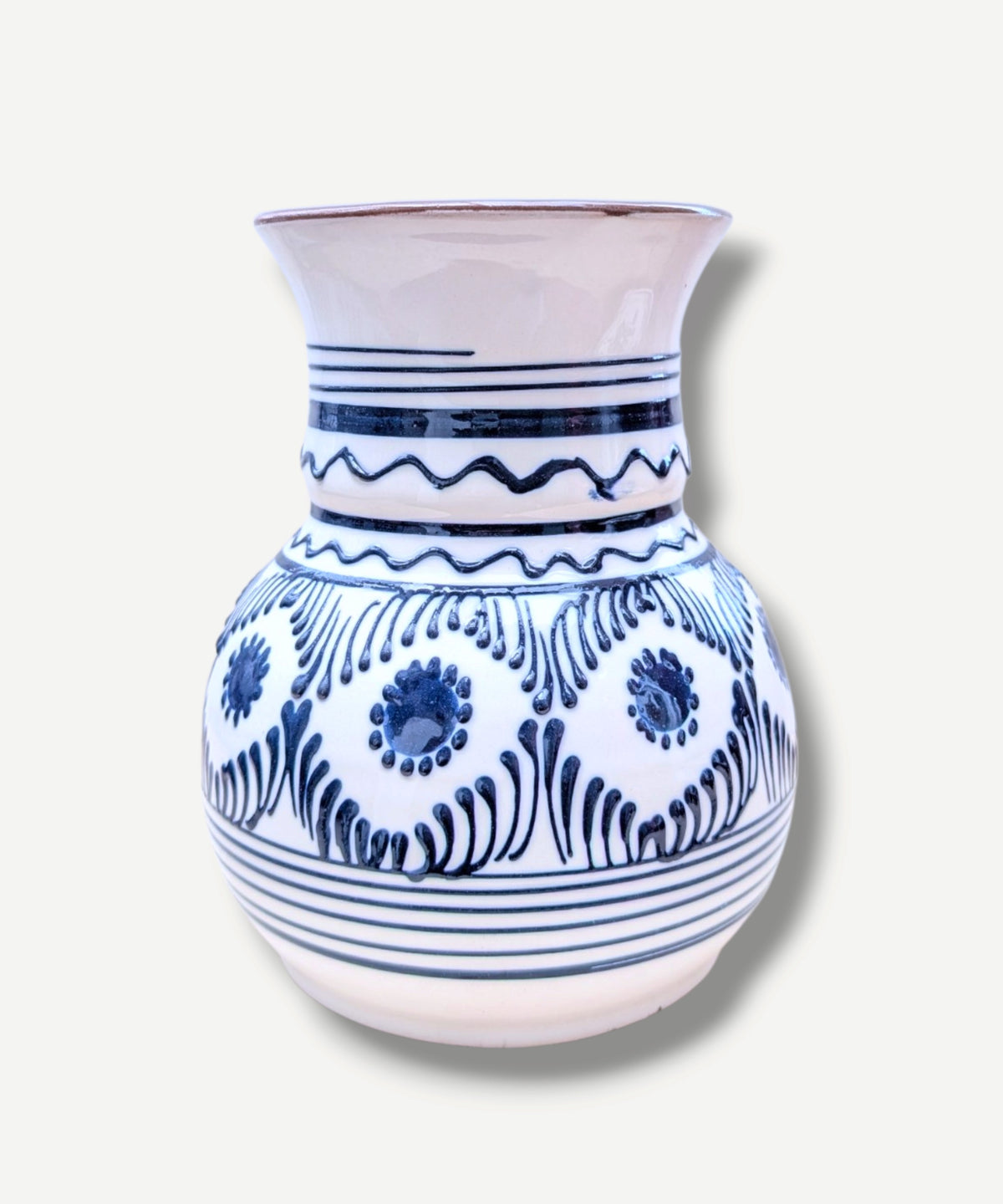 Casa De Folklore Handmade white Romanian earthenware vase with cobalt-blue wavy lines and dotted motifs and a brown interior.