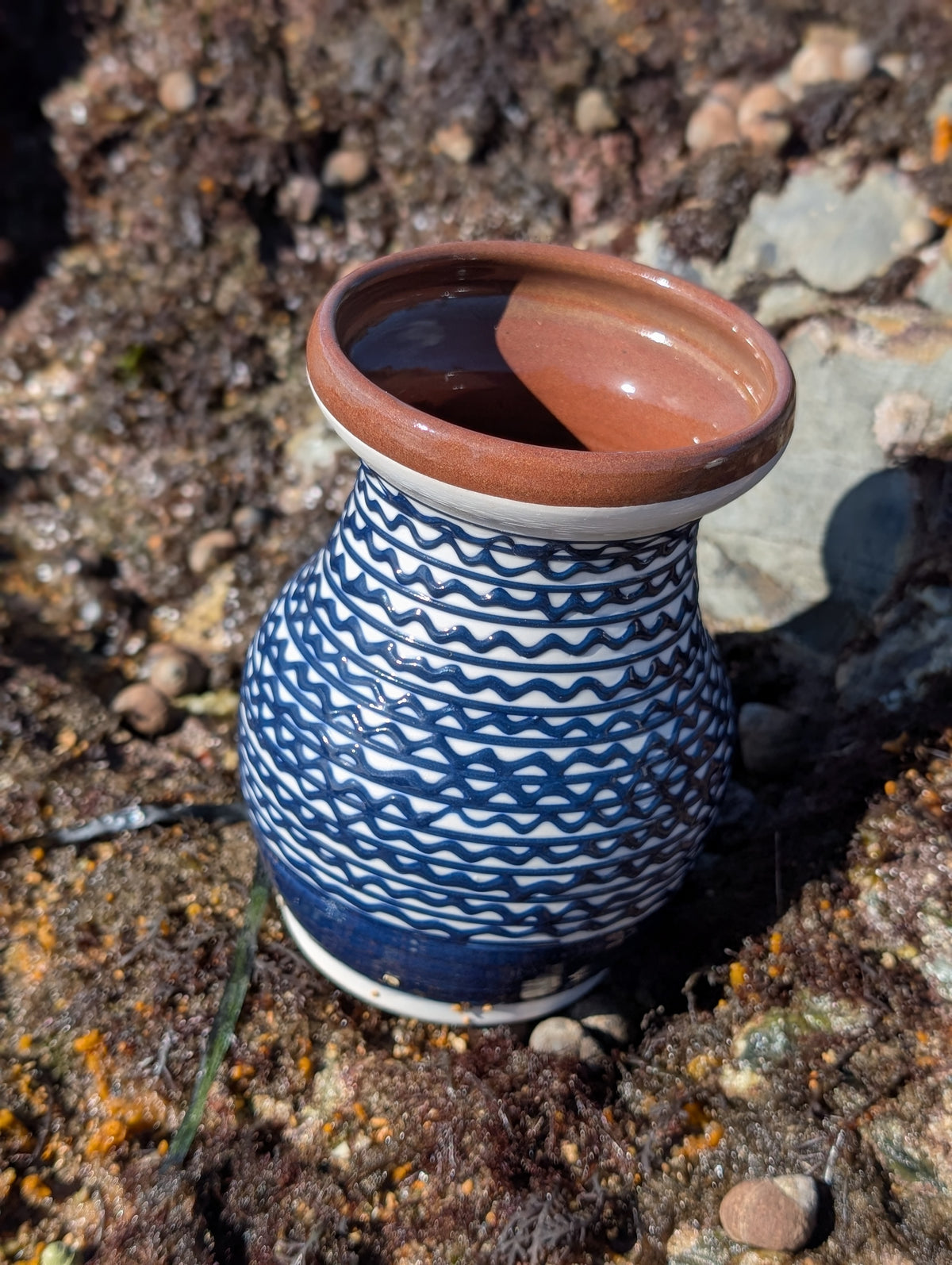 Handmade white Romanian earthenware vase with cobalt-blue geometric waves.
