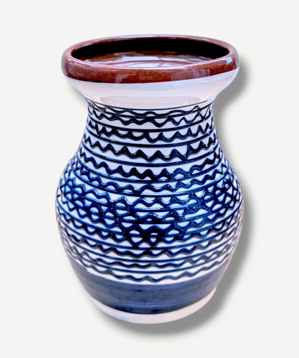 Handmade white Romanian earthenware vase with cobalt-blue geometric waves.