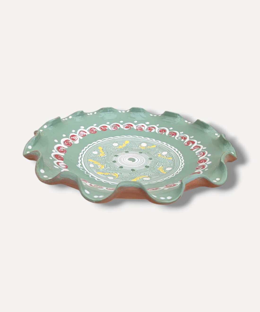 Decorative ceramic plate with floral patterns on a white background