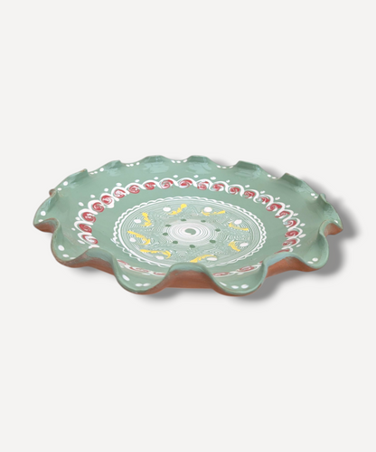 Decorative ceramic plate with floral patterns on a white background