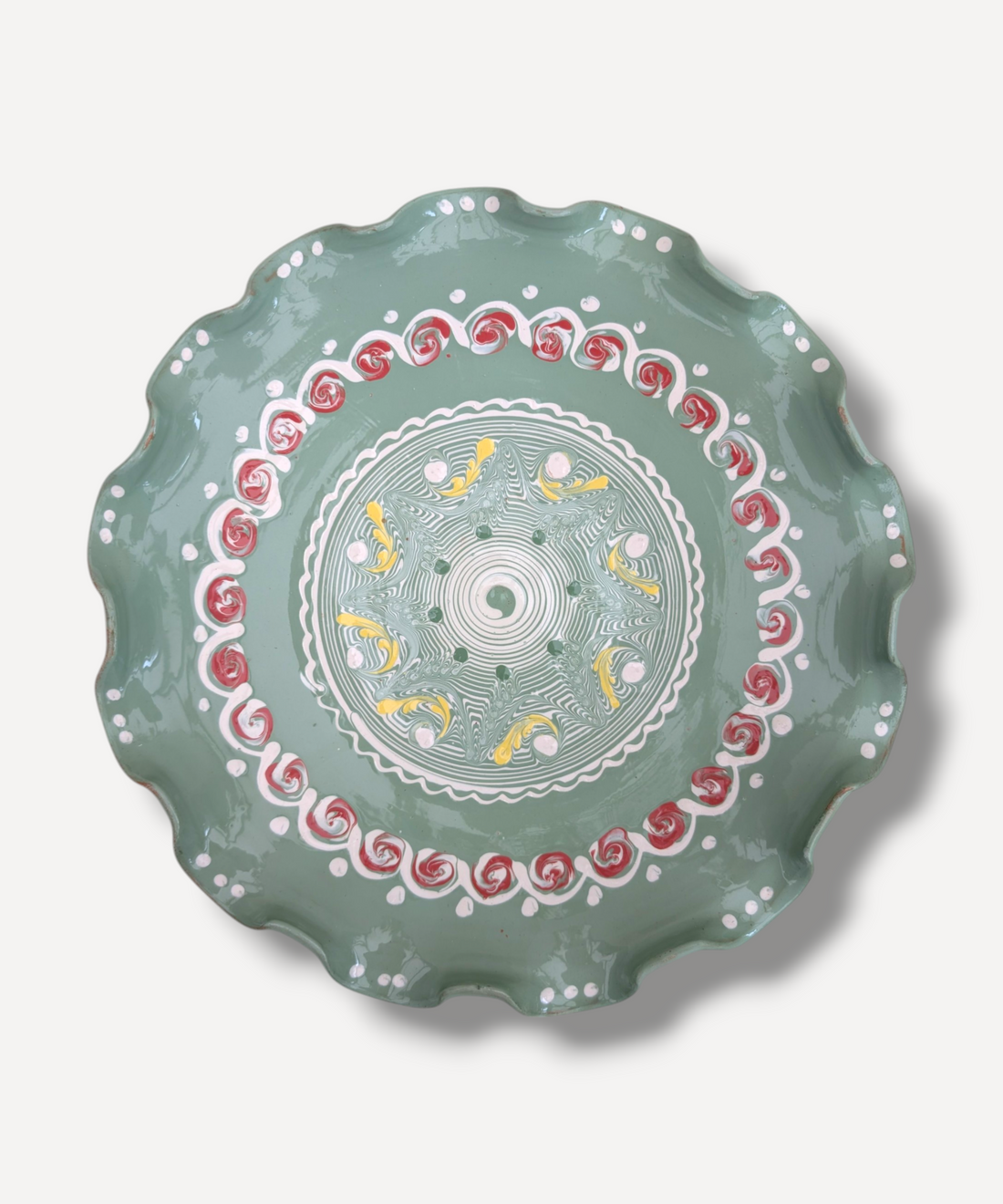 Decorative plate with intricate patterns on a light gray background