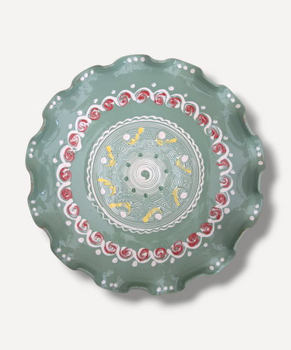 Decorative plate with intricate patterns on a light gray background