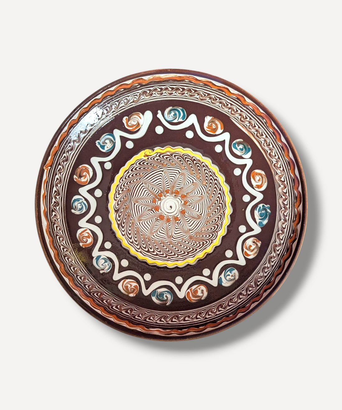 Decorative plate with intricate patterns on a white background